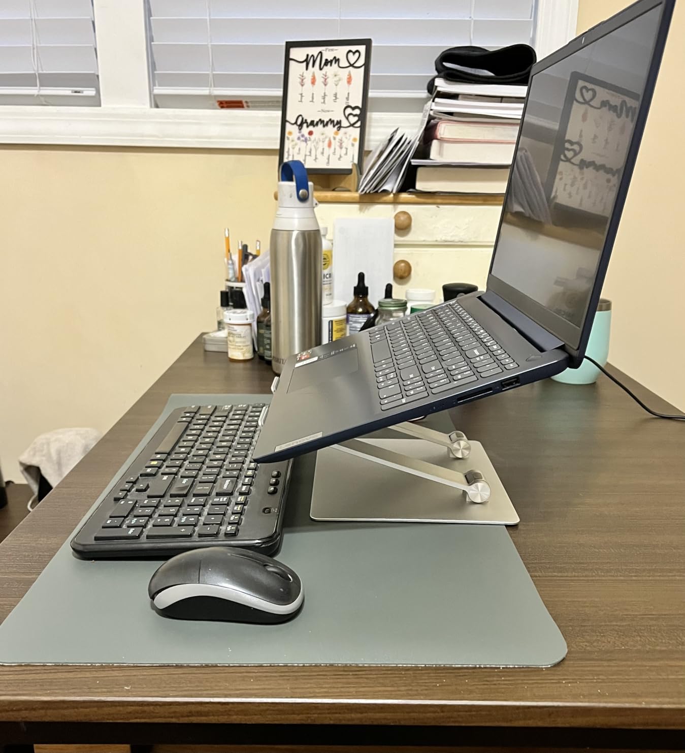 Amazon Basics Sturdy and Portable Ergonomic Laptop Stand for Desk, Height Adjustable Riser with Ventilated Cooling, Foldable, Fits all Laptops up to 15.6 Inch, Silver customer photo 2